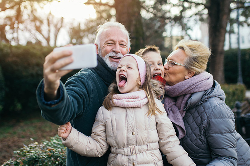 Grandparents taking selfie with kids