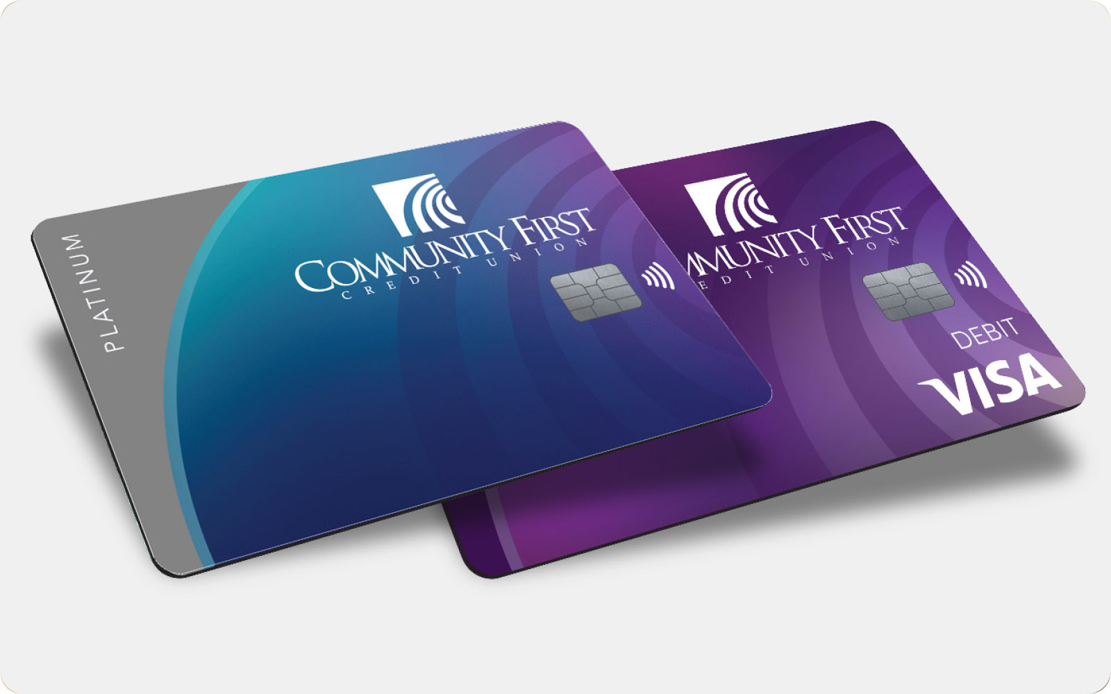Community First Credit Union Platinum in teal and gray and Visa Debit Card in purple.