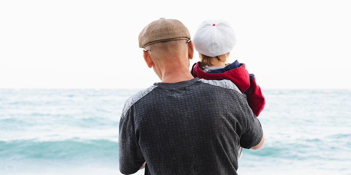 Grandpa and child looking at water.