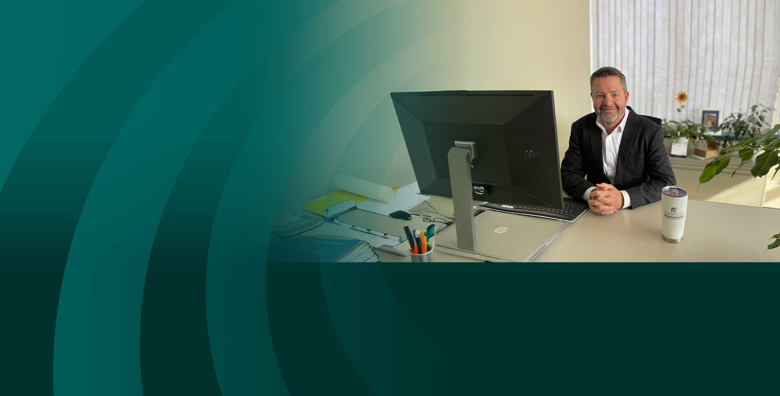 Man sitting at a desk waiting to help with financial investing