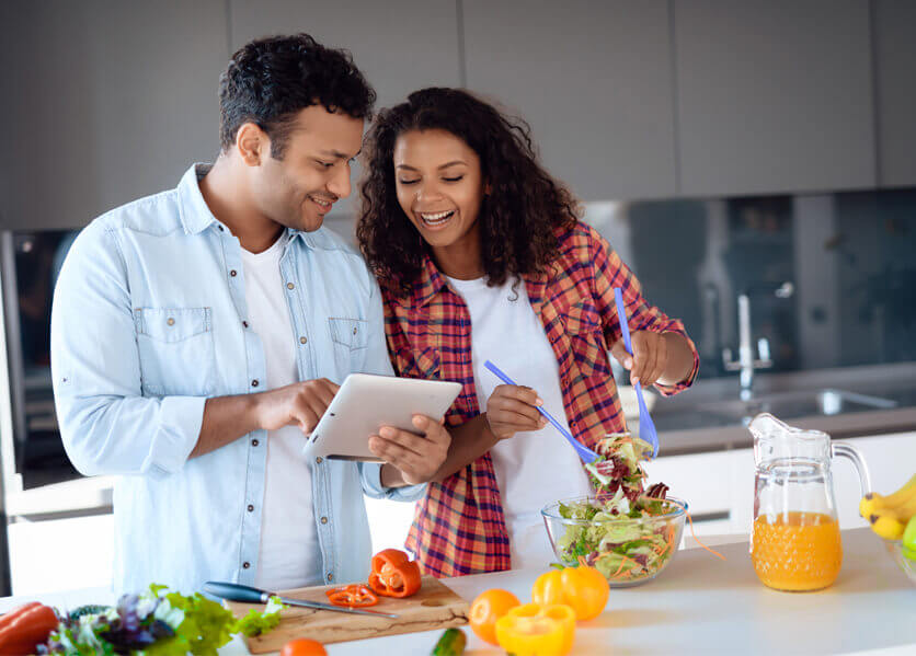 couple in kitchen cooking dinner.