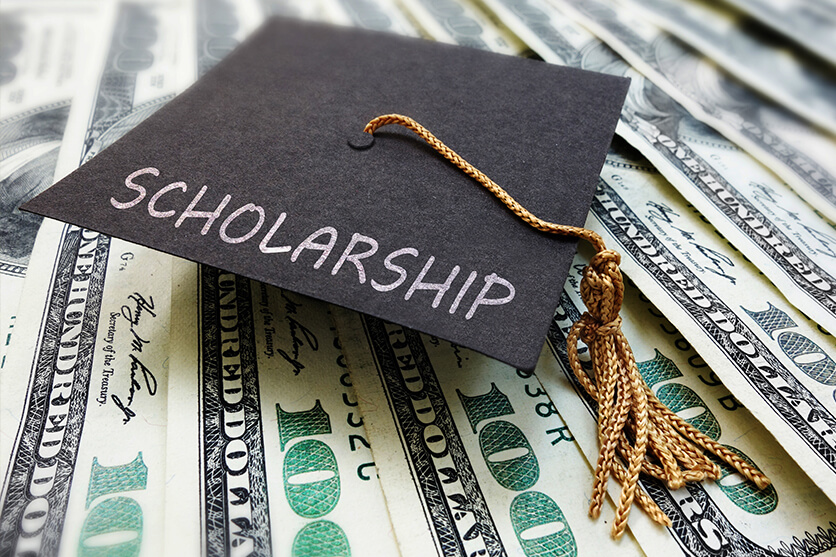 graduation cap on money.