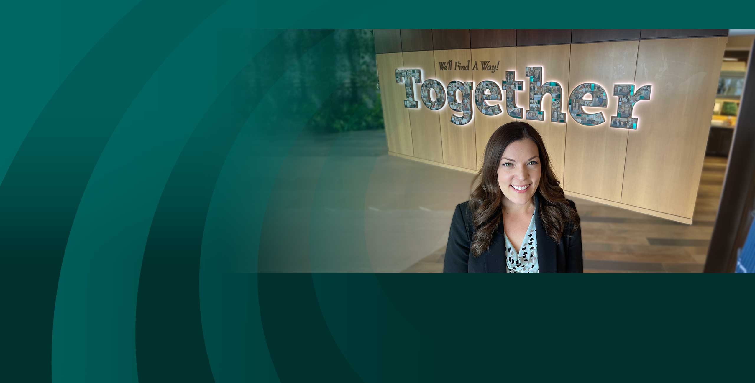 Woman standing in front of a We'll Find a Way Together sign as she connects with a Community First Credit Union financial advisor