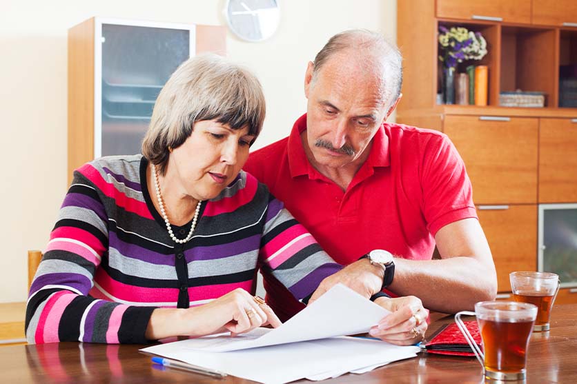Old couple looking at papers