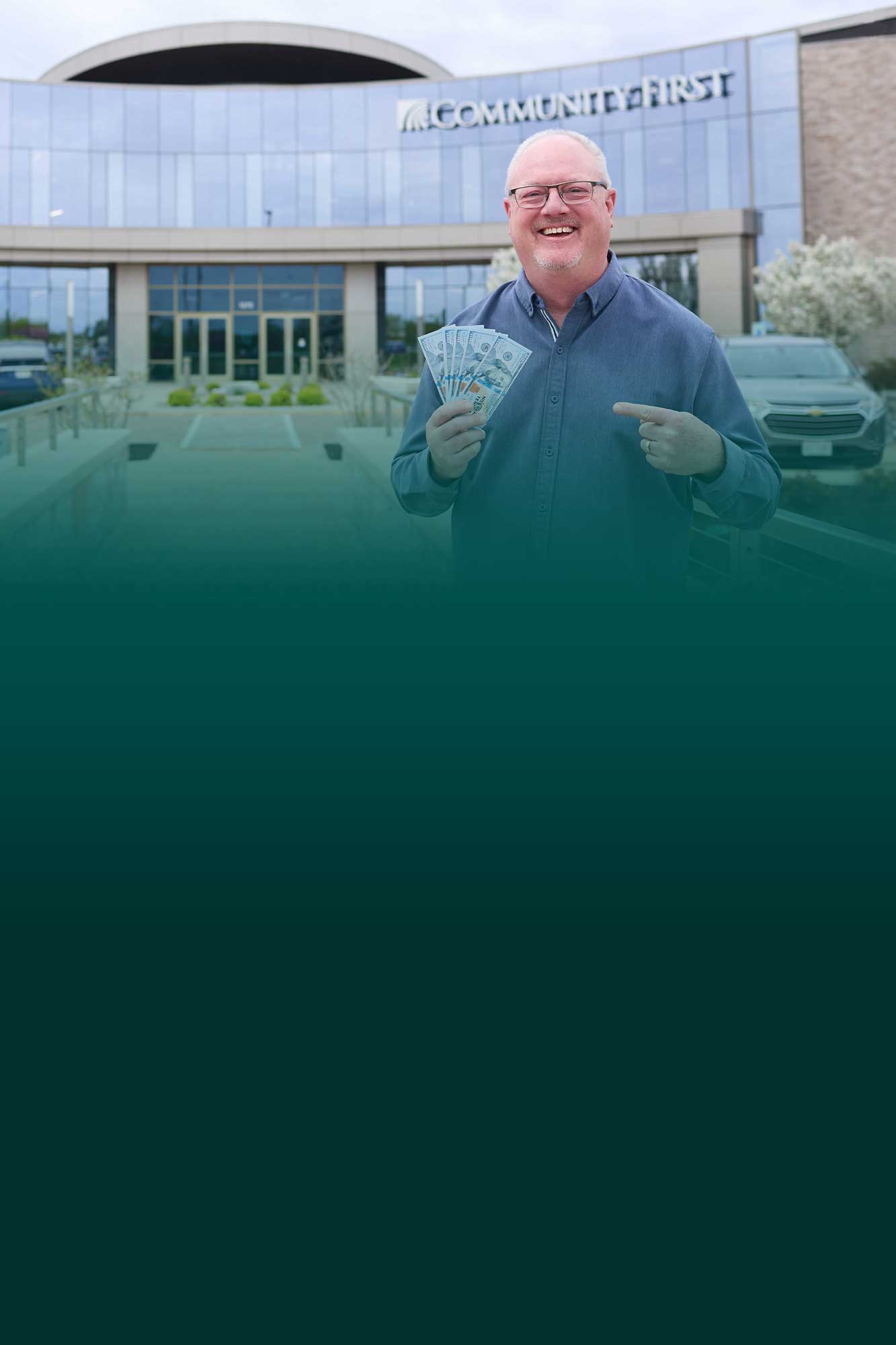 Member holding money in a Community First Credit Union branch.