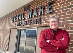 Carey in front of The Metal Ware Corporation