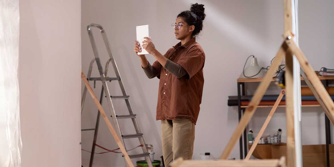 A woman working on home improvements that may help lower her tax bill.