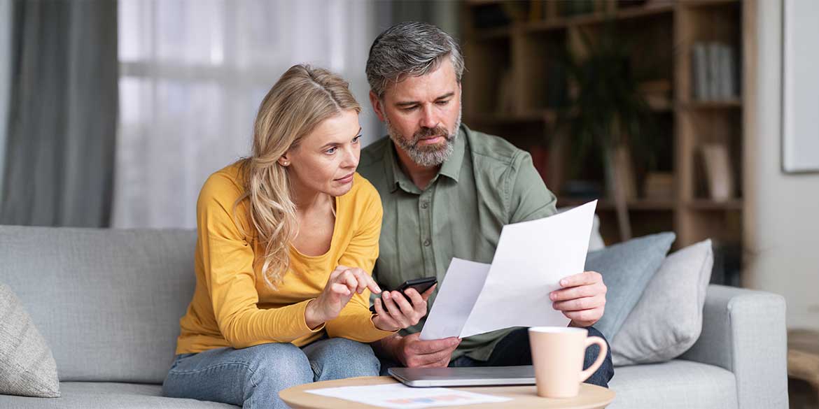 Man and Women Looking at Financial Documents