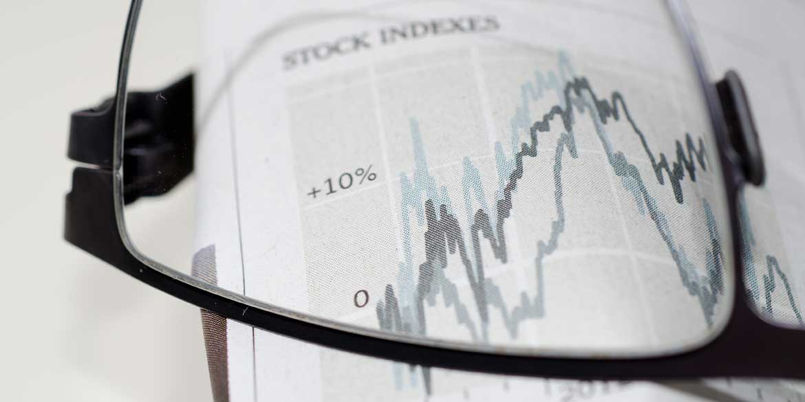 Glasses on an chart showing the market index measures