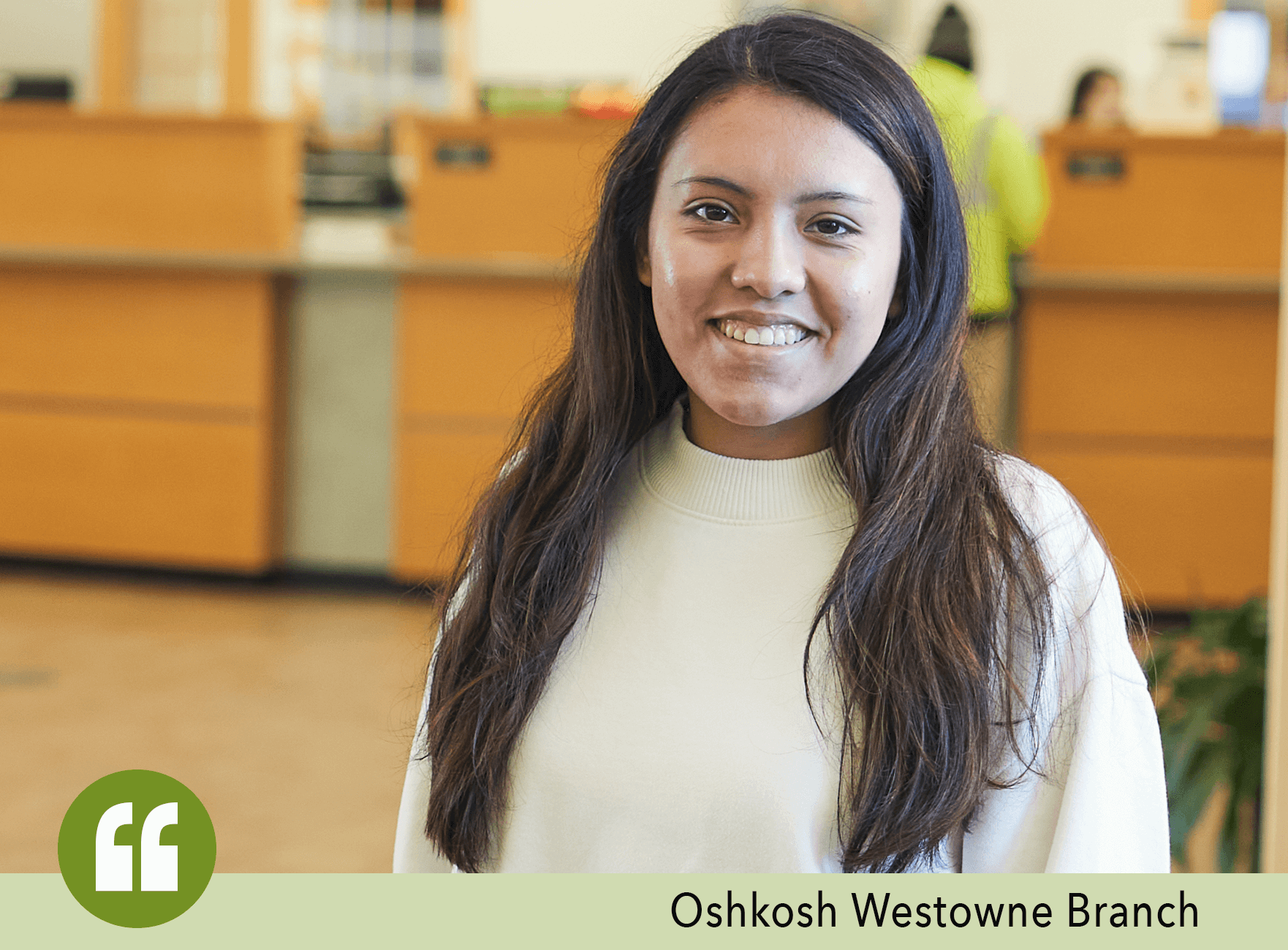 Woman with dark hair and white shirt inside the Oshkosh Westowne Branch of Community First