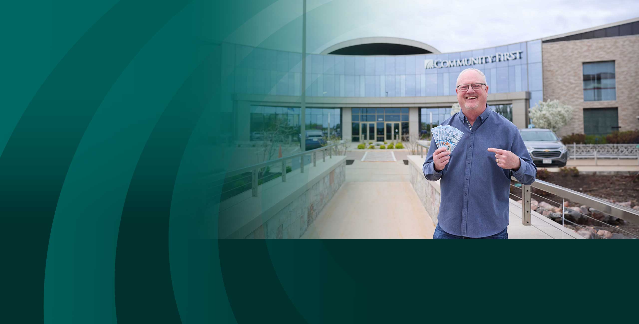 Member holding money in a Community First Credit Union branch.