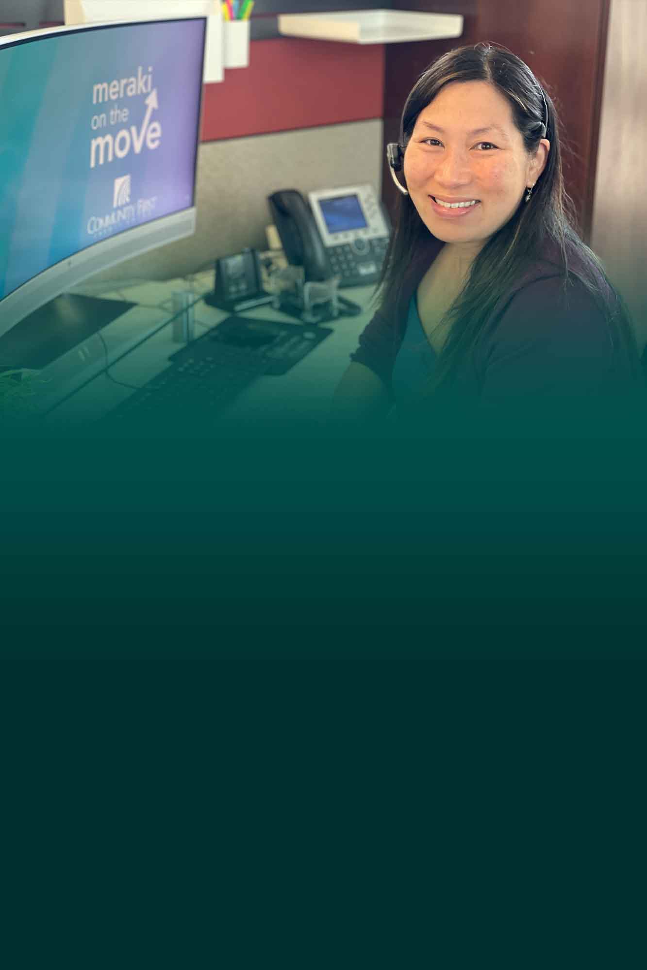 CFCU teammate behind desk helping a member.