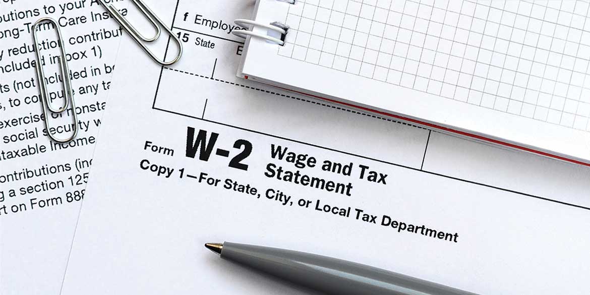 W-2 with notebook and paperclips.