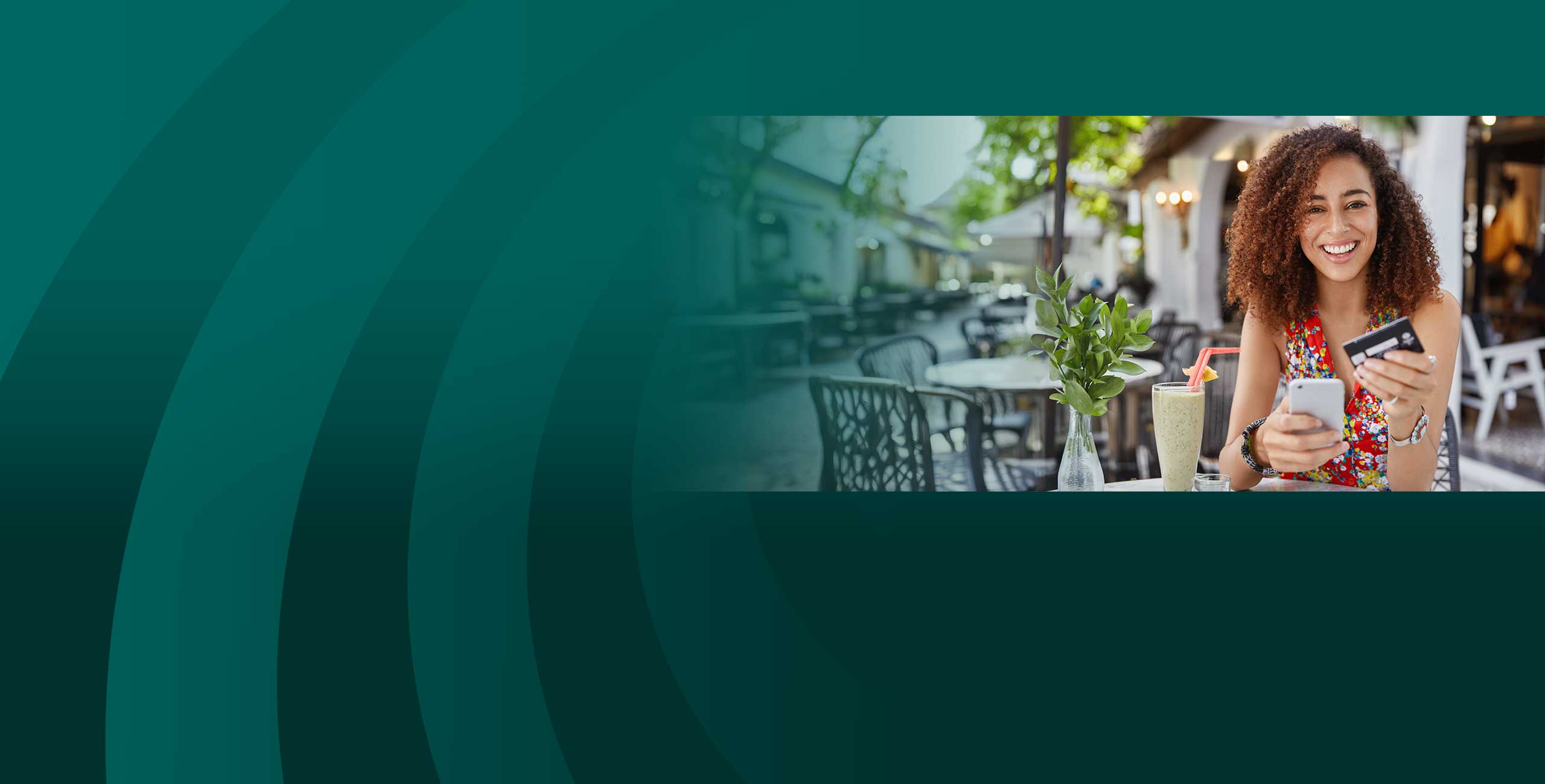 Smiling woman at a restaurant paying with a debit check card