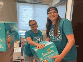 CFCU Volunteers Stacking Diapers at the House of Hope Diaper Drive