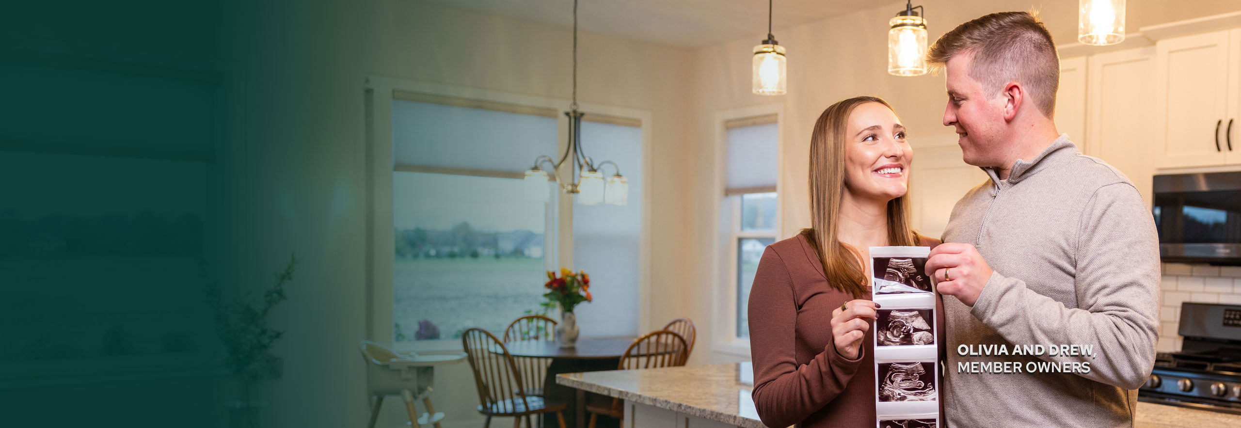 Couple holding baby photos