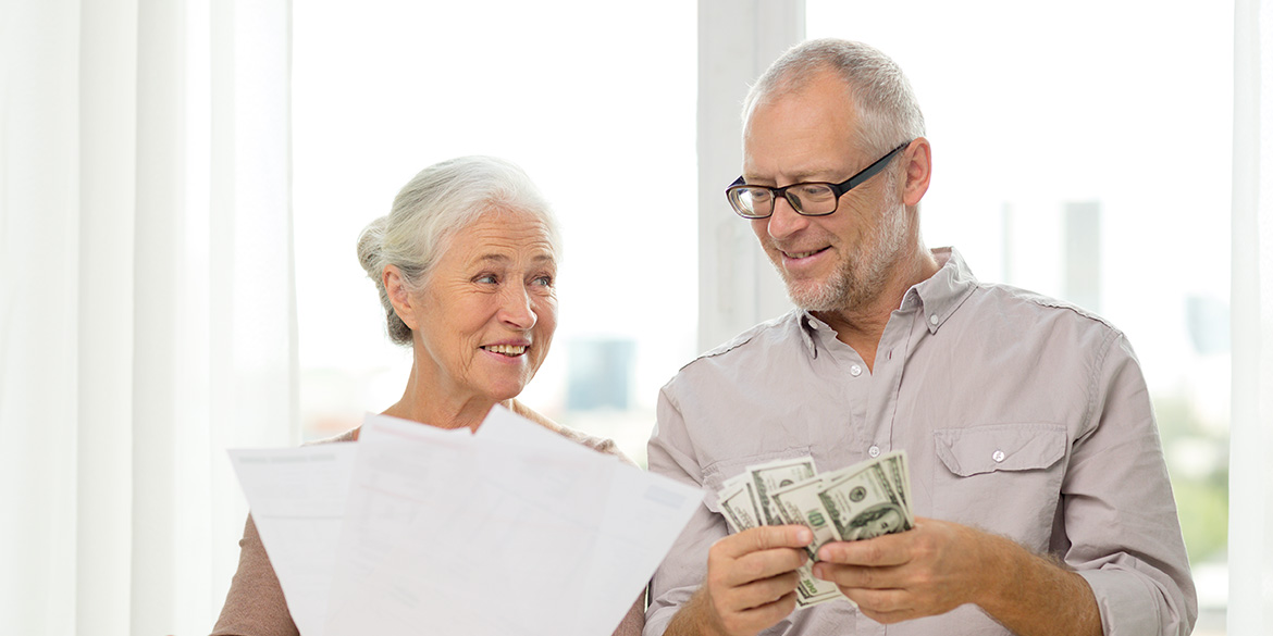 Man with money and woman with paper reviewing their financial needs