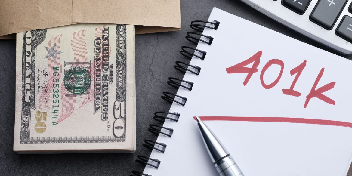 Dollars and notebook with 401K  written in red pen