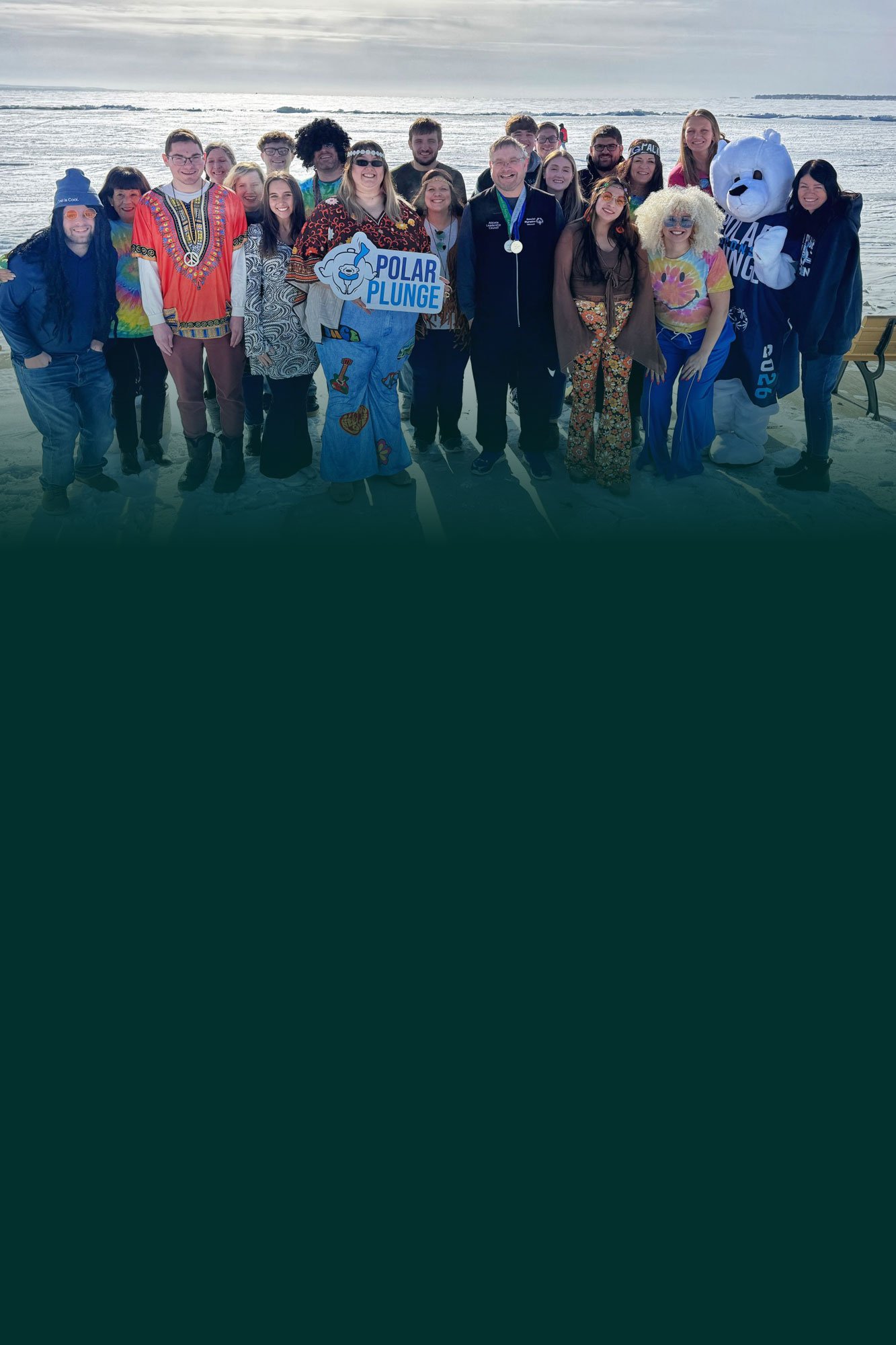 Group of people posing for portrait outdoors collecting trash to keep community clean