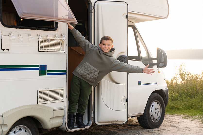 Smiling kid on a camper step because of an anytime loan from Community First Credit Union