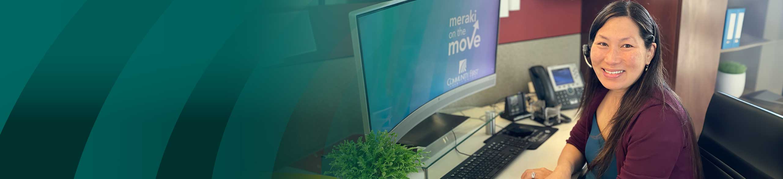 CFCU teammate behind desk helping a member.